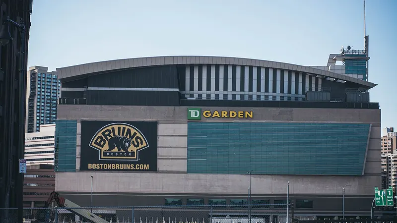 The front of TD Garden arena in Boston under a clear sky, with its name in large letters