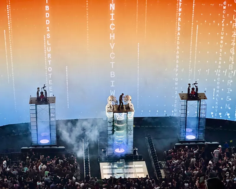 Anyma on a lit tower stage inside Sphere in Las Vegas, above a large crowd